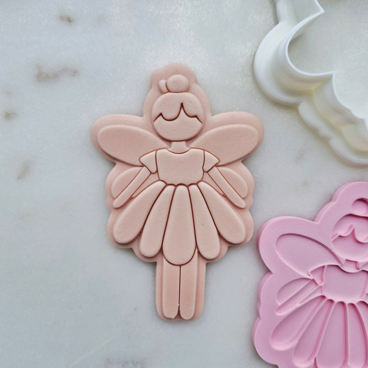 Fairy Cookie Cutter and Stamp zoomed in on white marble stone