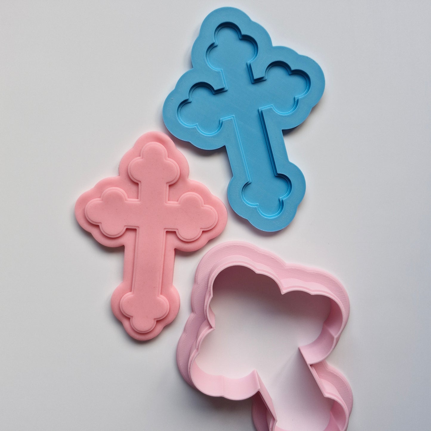 cross cookie cutter with deboss stamp that has stamped and cut in the shape of the fondant on white background Decorative Orthodox Cross Cookie Cutter and Deboss Stamp