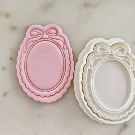 Set of cookie cutters with a pink and white design on a marble surface