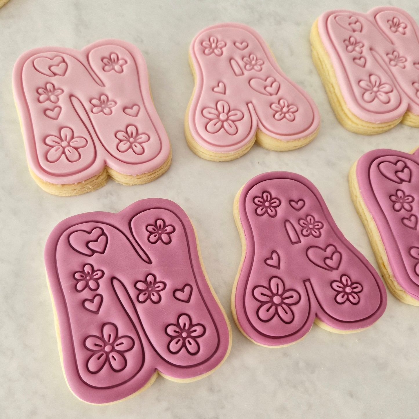 Groovy Nan Cookie Cutter and Stamp Set close up on N and A letters showing the flowers and love hearts designs on it, on white background