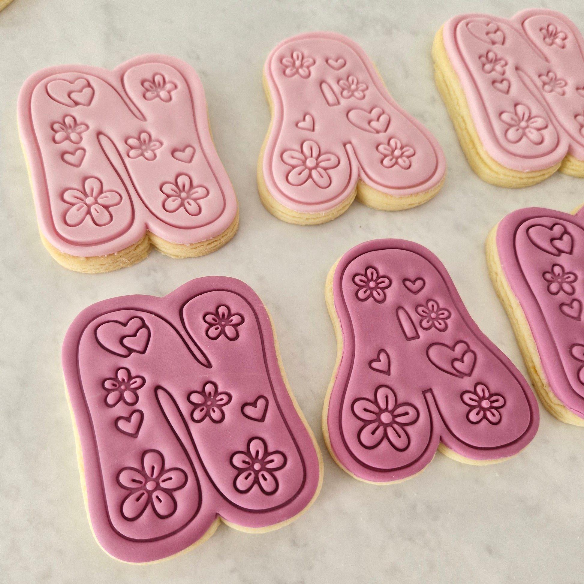 Groovy Nan Cookie Cutter and Stamp Set close up on N and A letters showing the flowers and love hearts designs on it, on white background