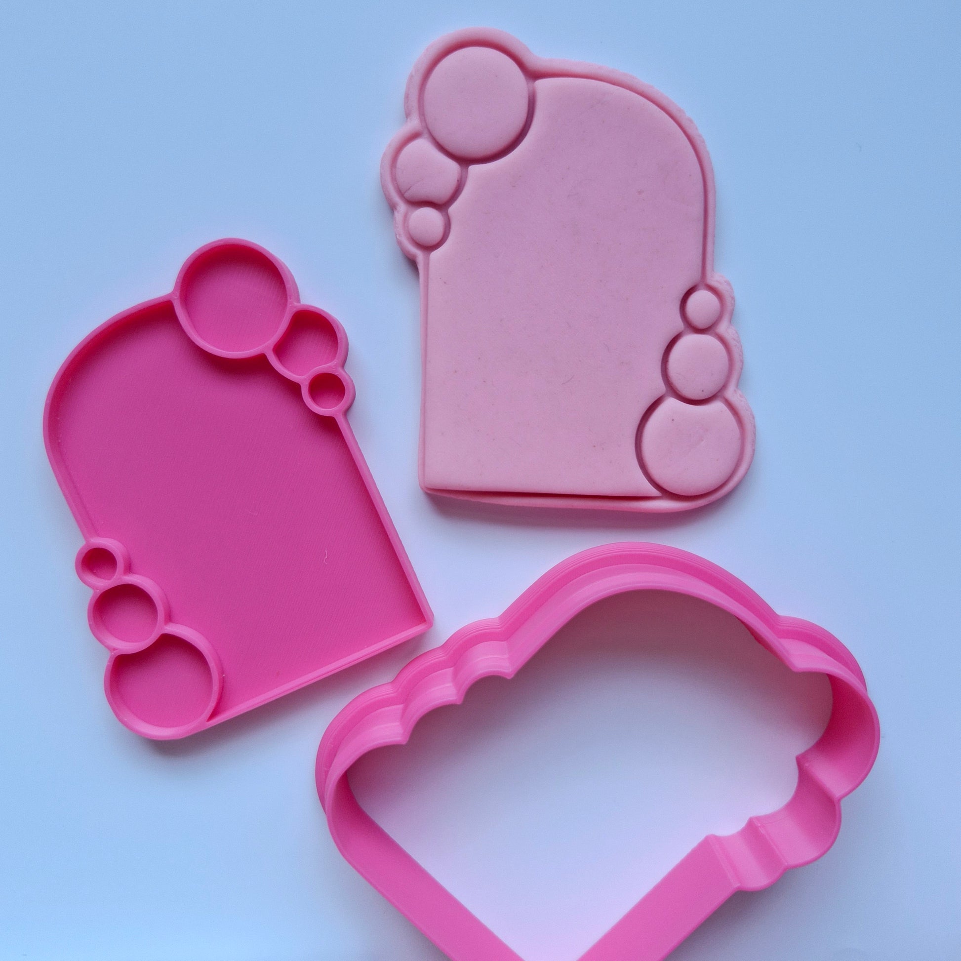 Bubble Frame Cookie Cutter and Stamp pink cookie cutter stamp and fondant stamped and cut in the shape of arch frame with bubbles around it 