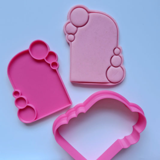 Bubble Frame Cookie Cutter and Stamp pink cookie cutter stamp and fondant stamped and cut in the shape of arch frame with bubbles around it 