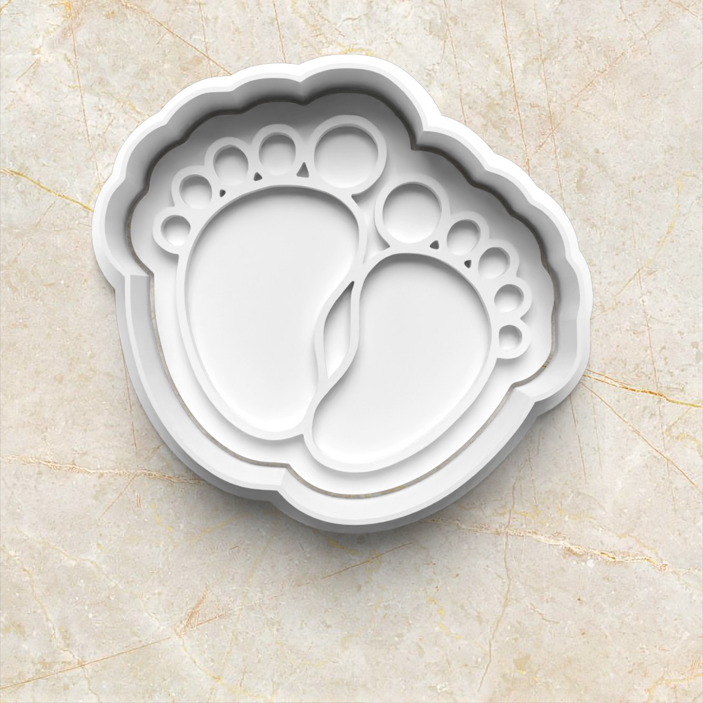 Baby Set Cookie Cutter and Emboss Stamp - Baking Tool - Baking Tool, in the shape of baby feet, on yellow marble