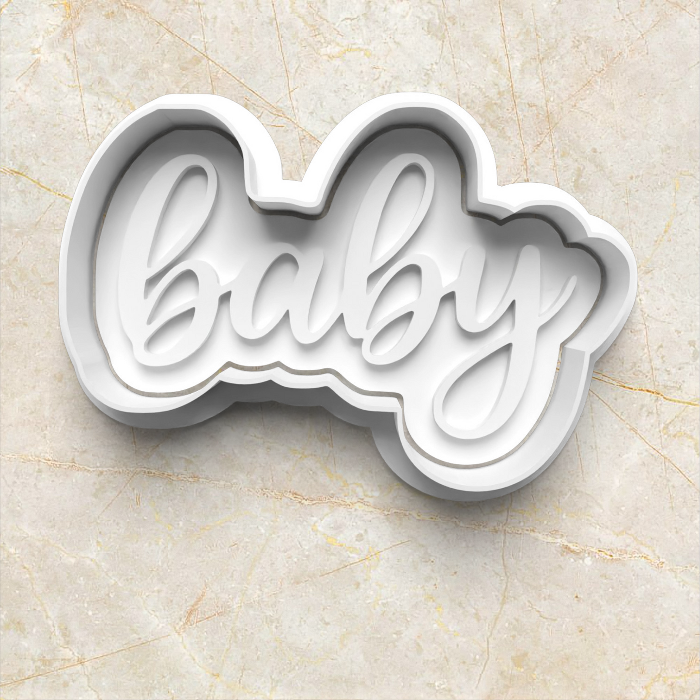 Baby Set Cookie Cutter and Emboss Stamp - Baking Tool, in the shape of the word baby, on yellow marble
