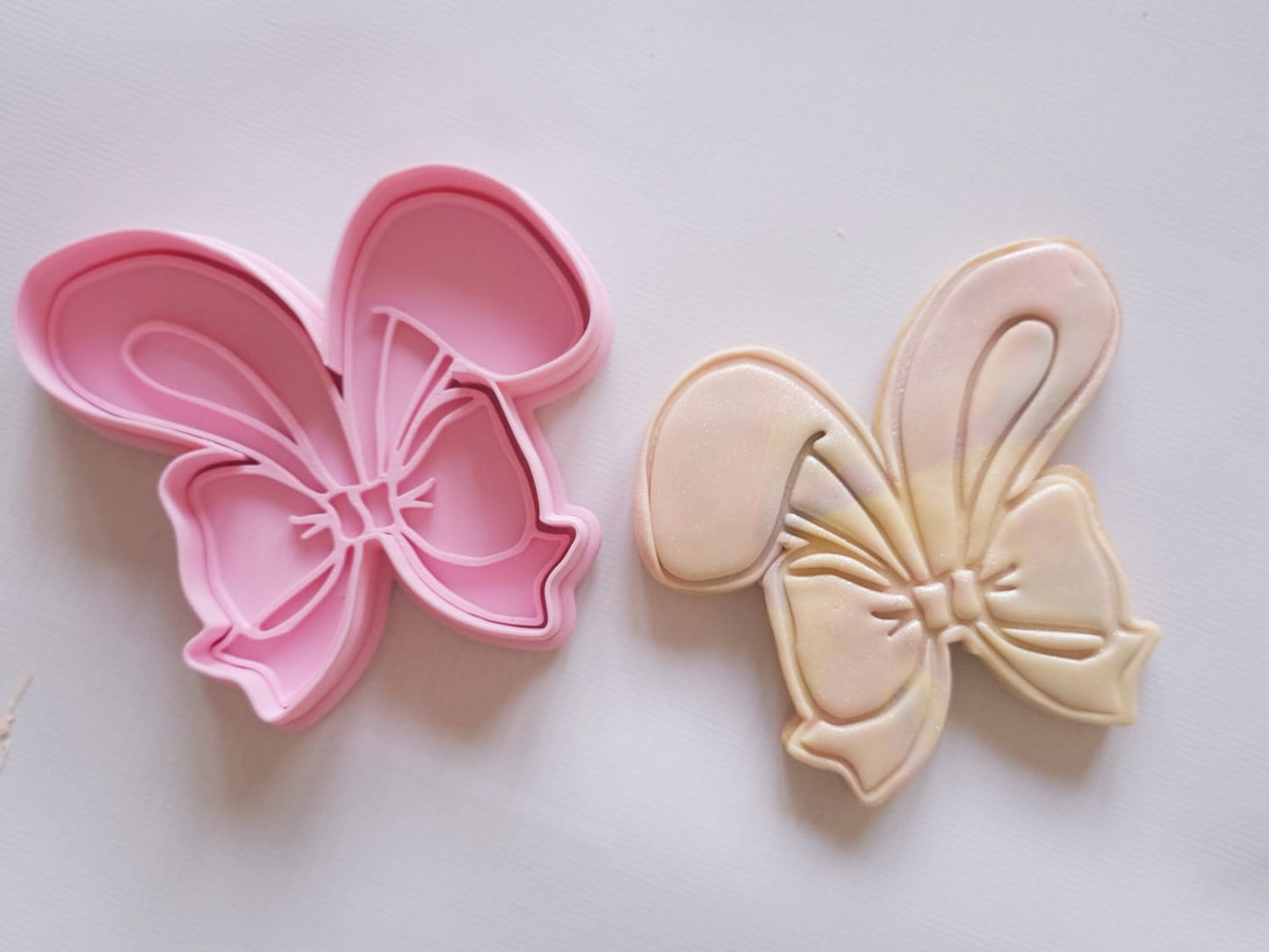 sugar cookie and cookie cutter and stamp of bunny ears wrapped with bow Coquette Bunny Ears Cookie Cutter and Stamp