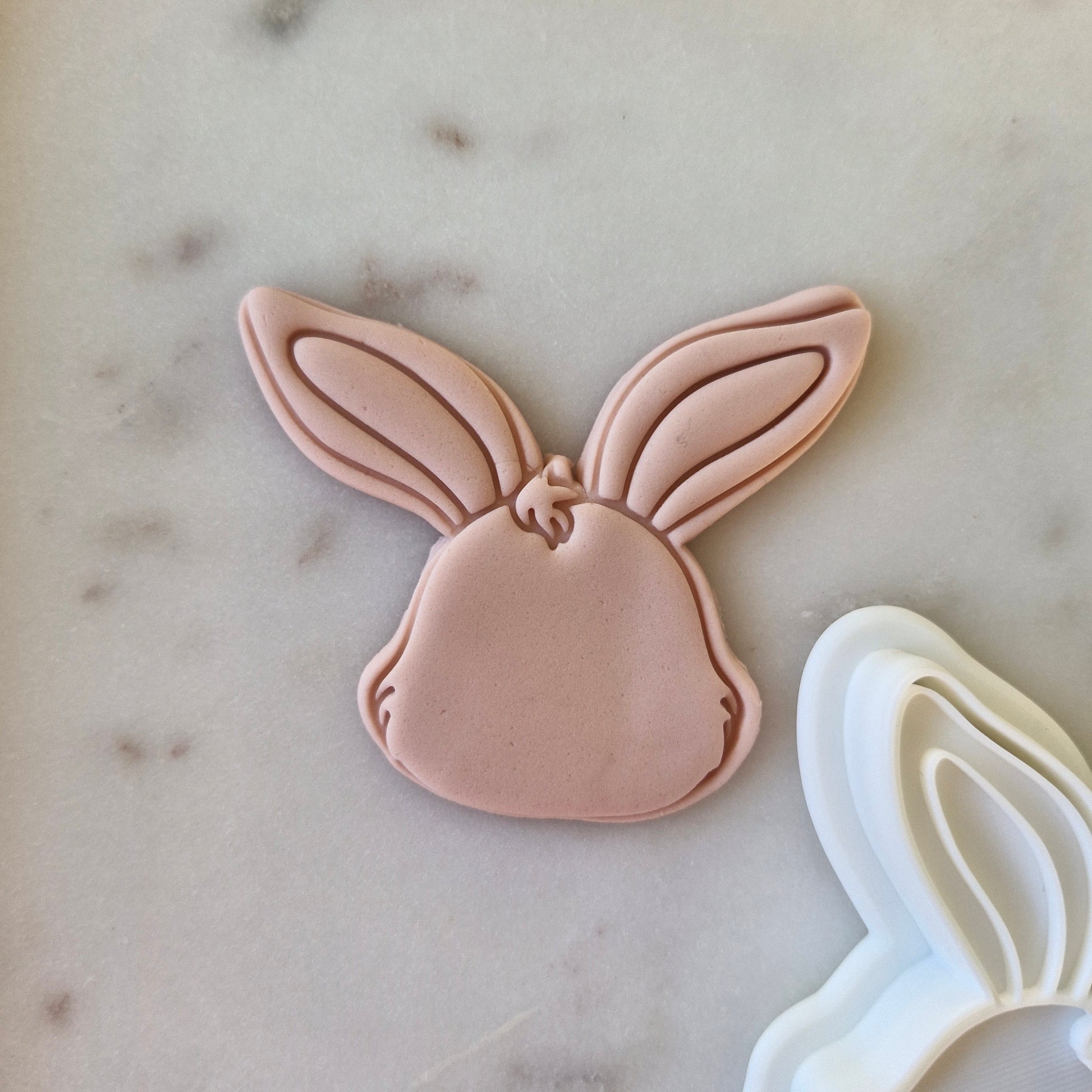  Bunny Head Cookie Cutter and Stamp on fondant and white marble background