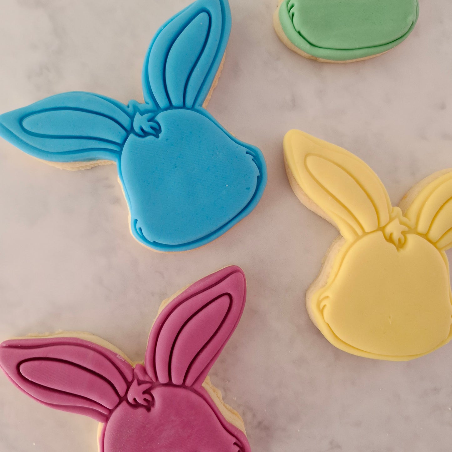  Bunny Head Cookie Cutter and Stamp in yellow blue green and dark pink on white marble background