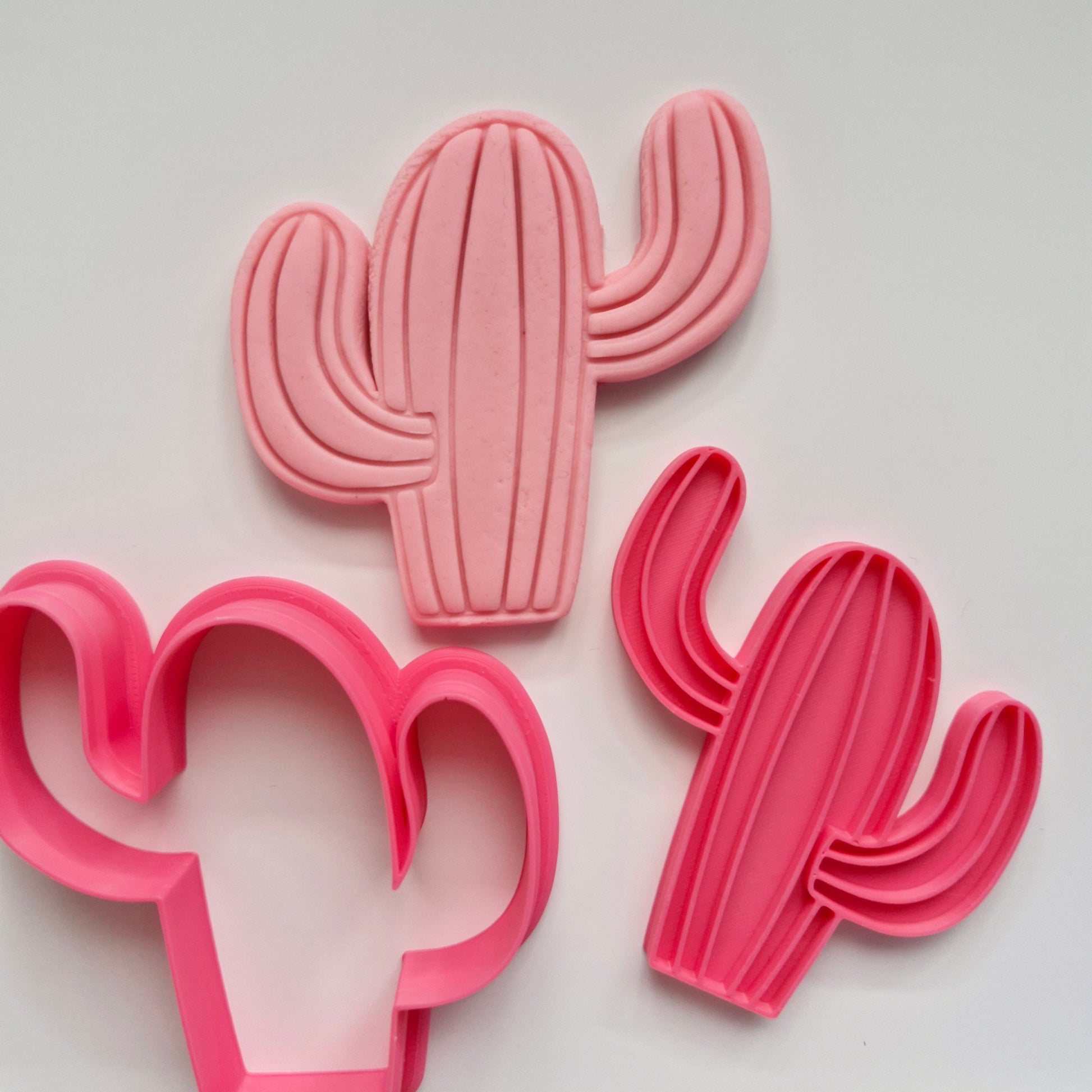 pink cookie cutter and stamp, on pink fondant making the shape of a cactus, on white background .Cactus Cookie Cutter and Emboss Stamp - Baking Tool Cactus, Cookie Cutter and Stamp