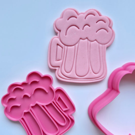 pink fondant stamped with the shape of a chunky mug beer with foam, cookie cutter and stamp in pink on white background Chunky Beer Cookie Cutter and Stamp