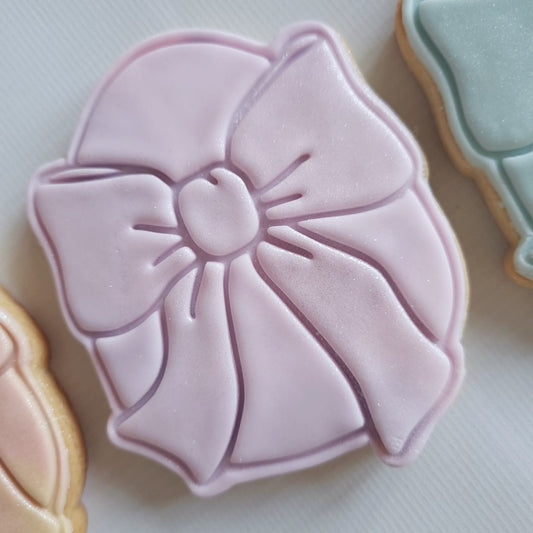 sugar cookie in the shape of easter egg with a big bow on it Egg with Bow Cookie Cutter and Stamp