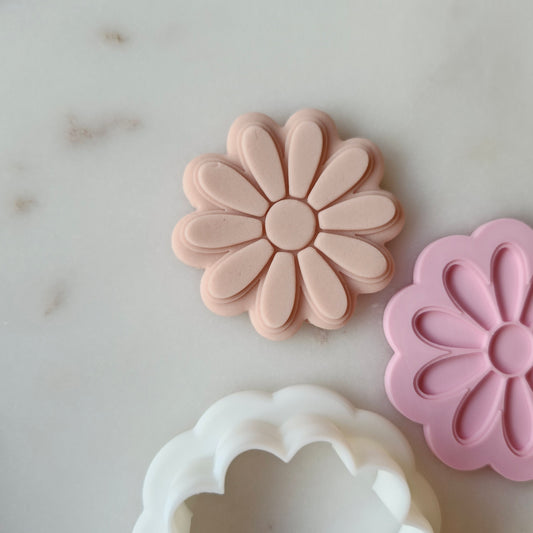 Daisy Cookie Cutter and Deboss Stamp zoomed in and on white marble background