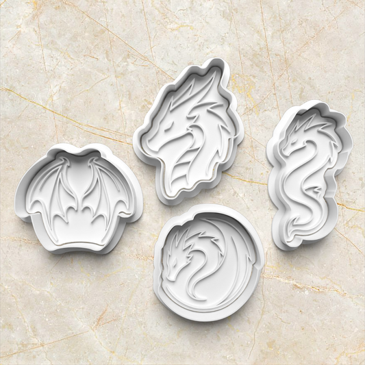 Set of four white dragon-shaped cookie cutters on a marble surface Dragon Set Cookie Cutter and Stamp
