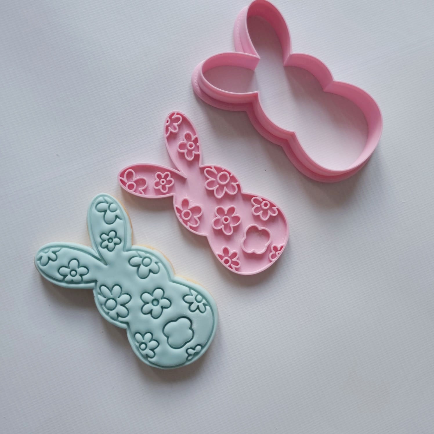 sugar cookie and cookie cutter with stamp, in the shape of bunny with daisy patters on them and white background Floral Bunny Silhouette Cookie Cutter and Stamp