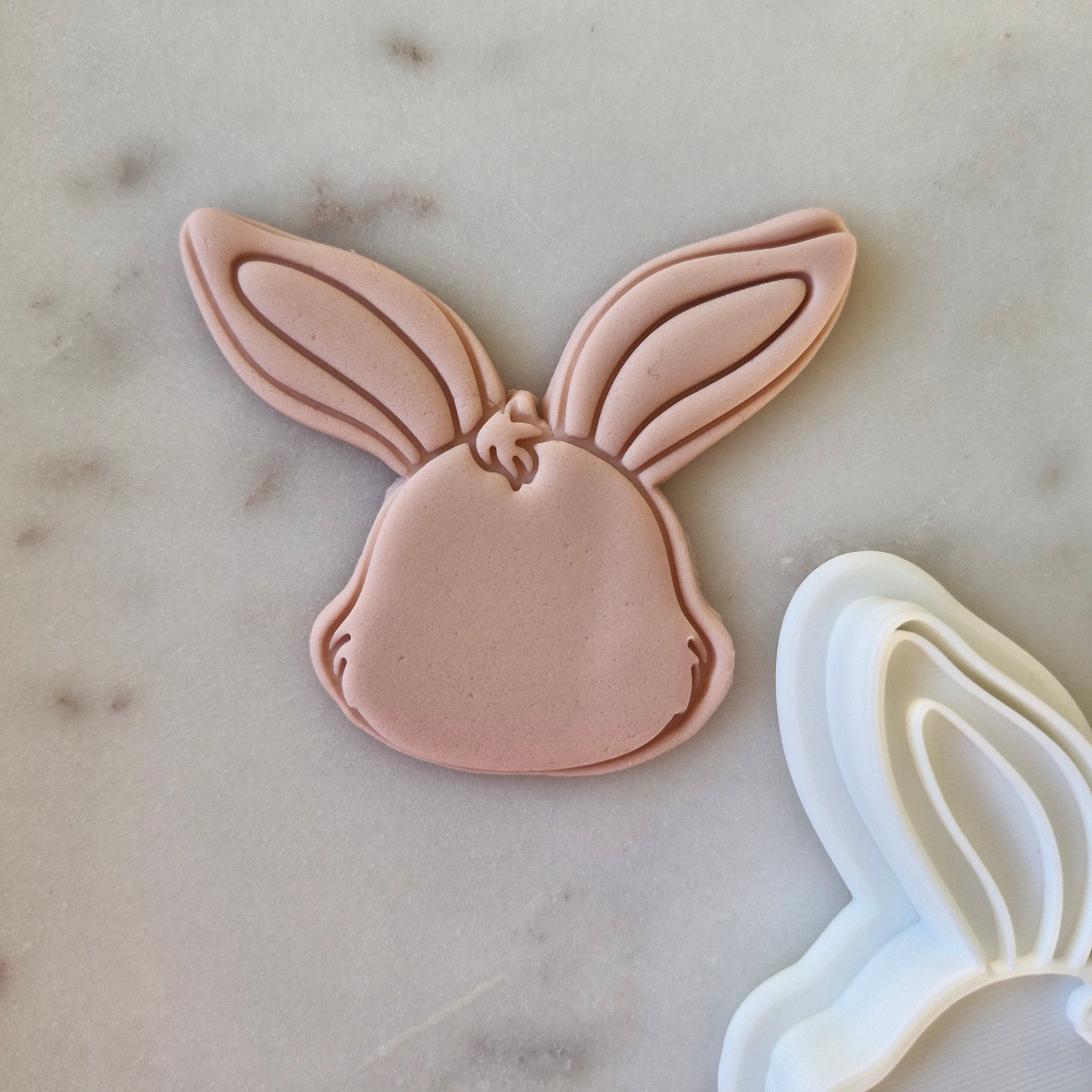  Bunny Head Cookie Cutter and Stamp on fondant and white marble background