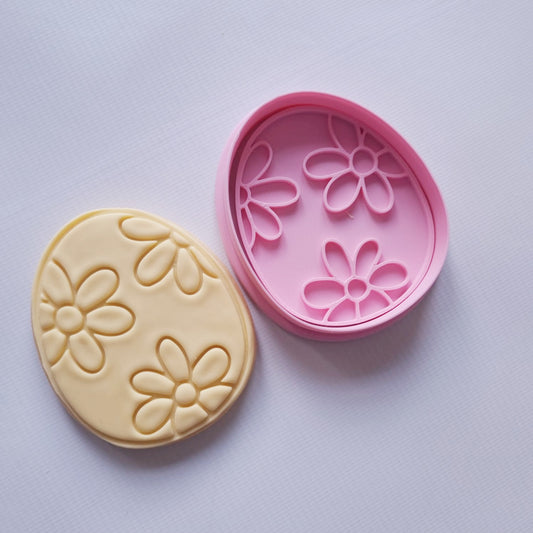 sugar cookie and cookie cutter and stamp in egg shape with daisy flowers pattern on it Floral Easter Egg Cookie Cutter and Stamp