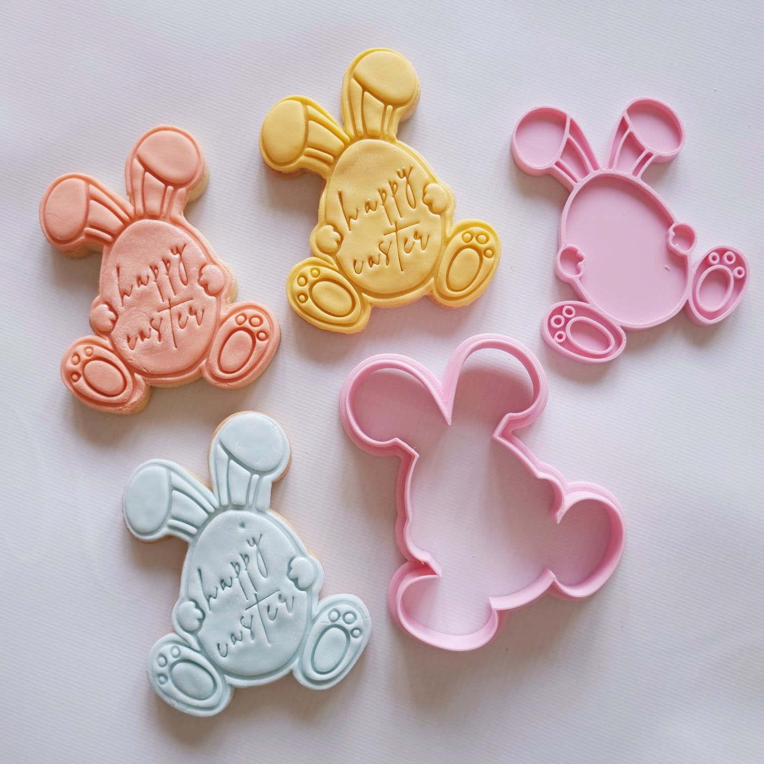 3 sugar cookies in shape of easter bunny holding waster egg with happy easter writing on the egg and cookie cutter and stamp Bunny Name Tag Cookie Cutter and Stamp