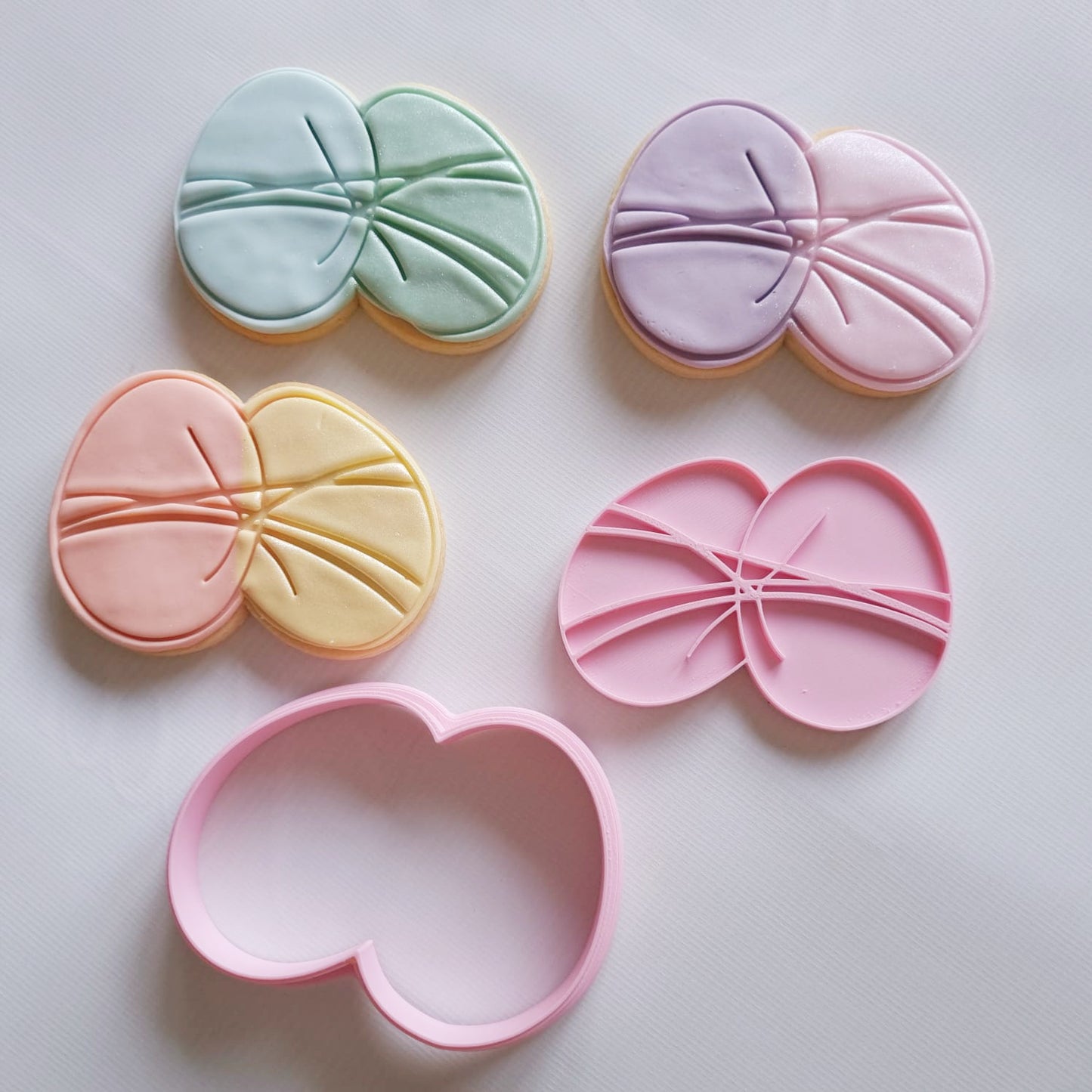 3 sugar cookies and cookie cutter with stamp that are in the shape of 2 eggs wrapped together Easter Eggs Cookie Cutter and Stamp