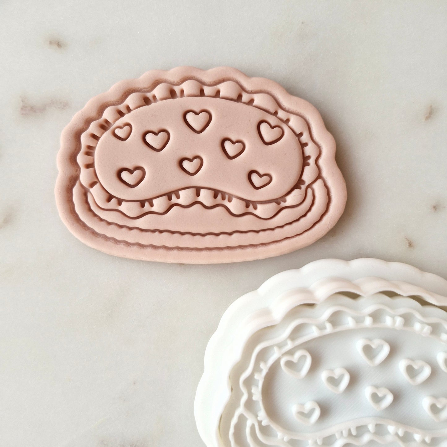 Mum Needs Her Sleep Cookie Cutter and Stamp SEt zoomed in on eye mask on white marble background