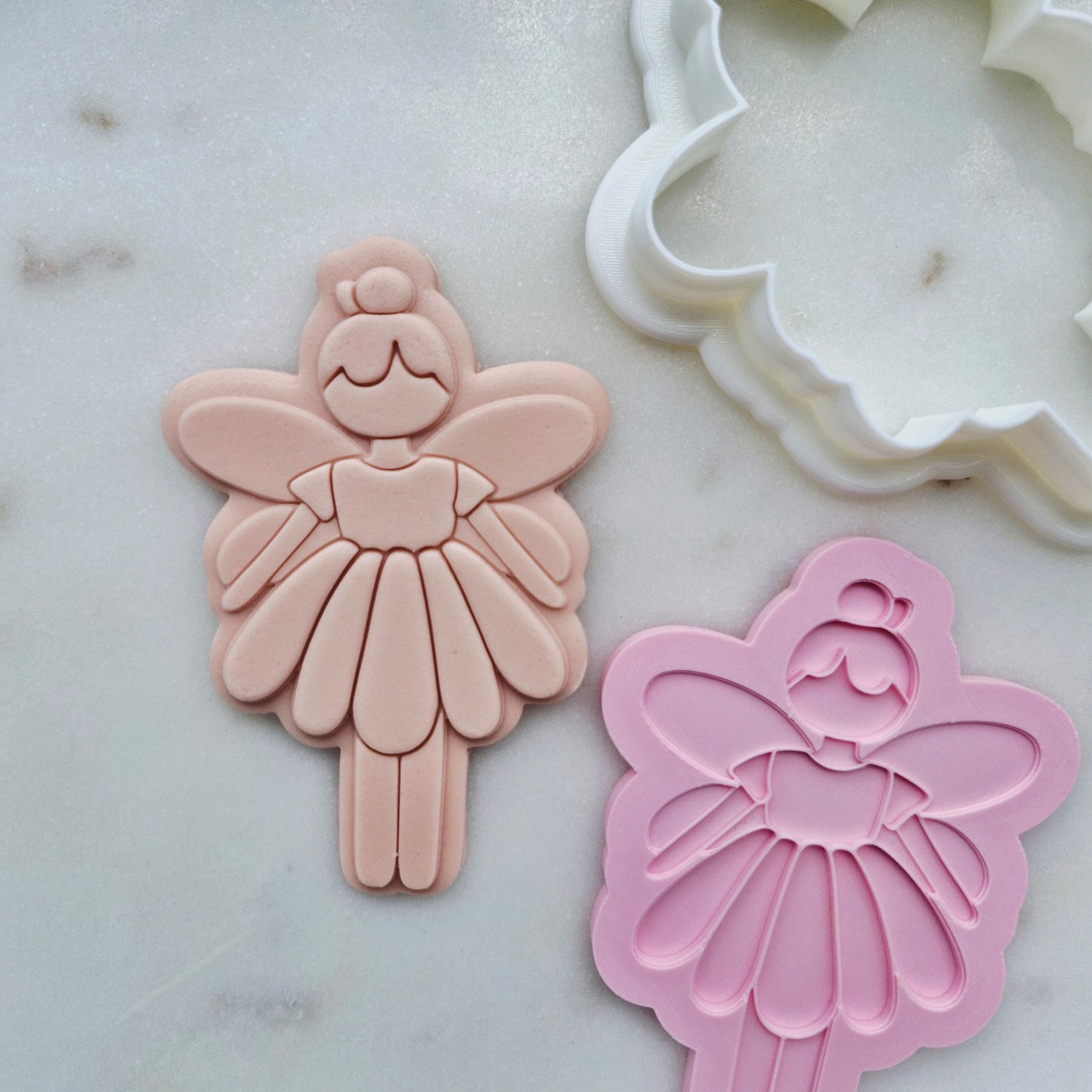 Fairy Cookie Cutter and Stamp zoomed out on white marble stone