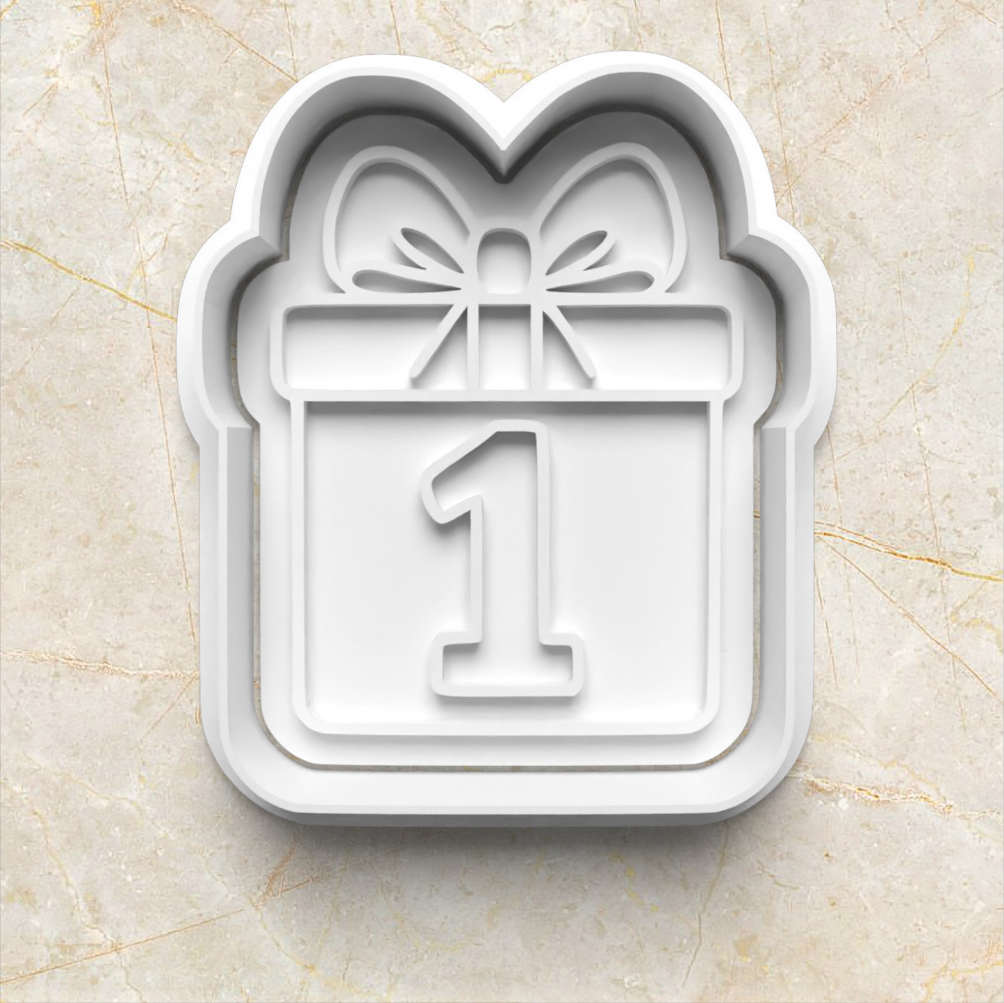 Beary First Birthday Cookie Cutter and Stamp present box with bow and number one in the middle on beige marble background