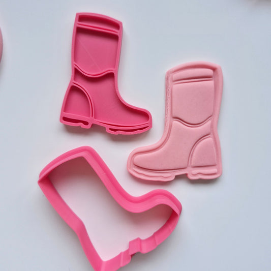 gumboots, pink fondant and cookie cutter and stamp on white background