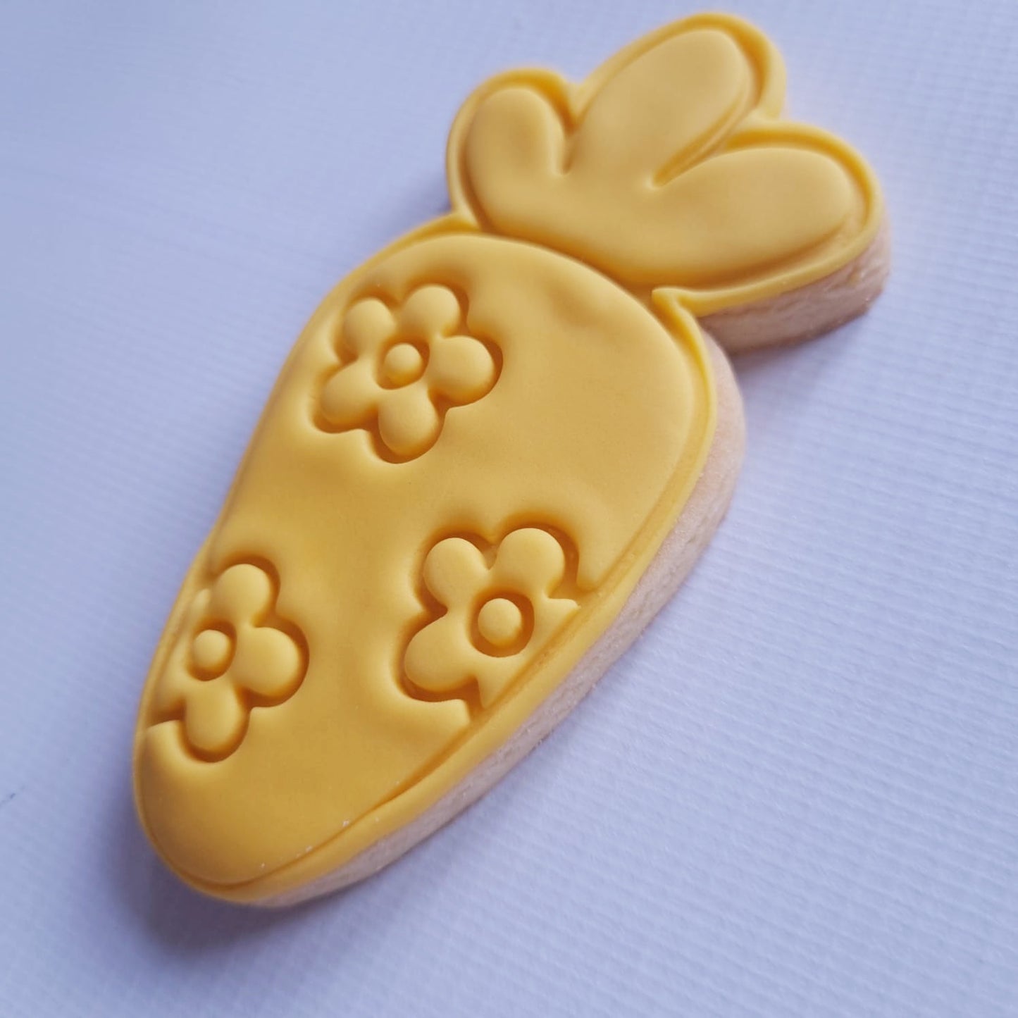 sugar cookie in carrot shape covered in daisy shape flowers Floral Easter Carrot Cookie Cutter and Stamp