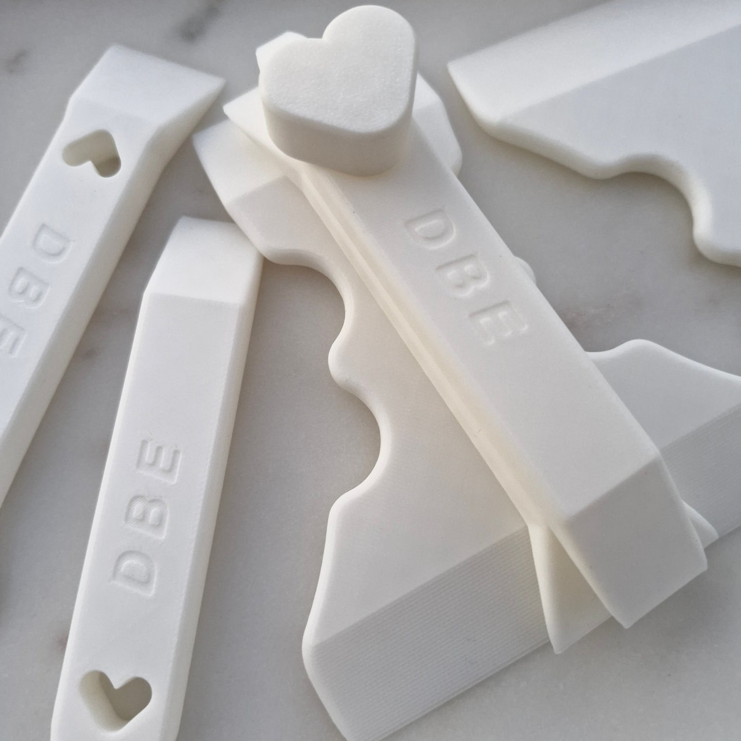 set of  fondant scrapers on marble background Fondant Scraper and Layering Tools Dual-Sided Set with Holder