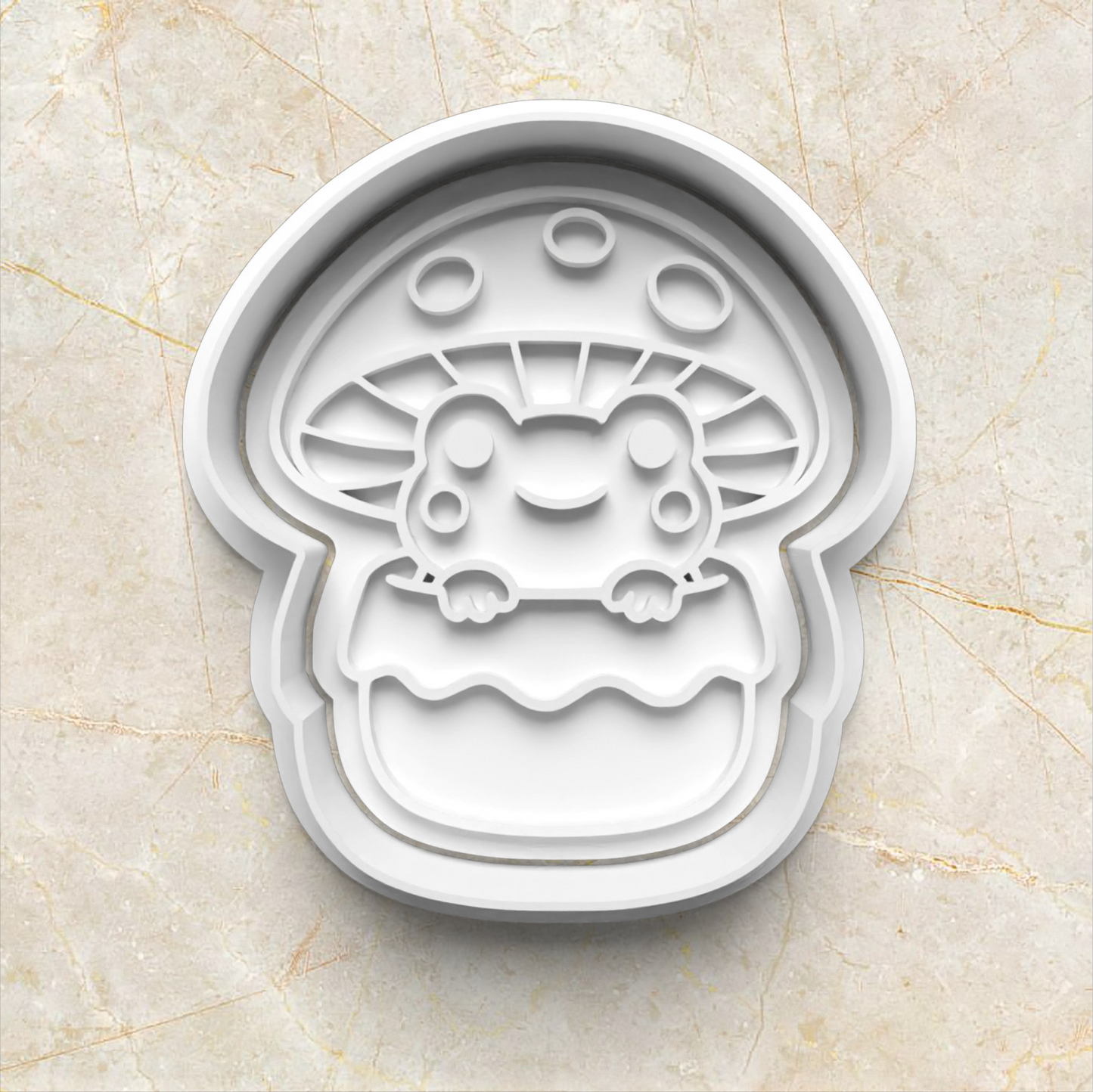 Cookie cutter shaped like a cartoon character frog inside a mushroom on a marble surface Mushroom Frog Set Cookie Cutter and Stamp