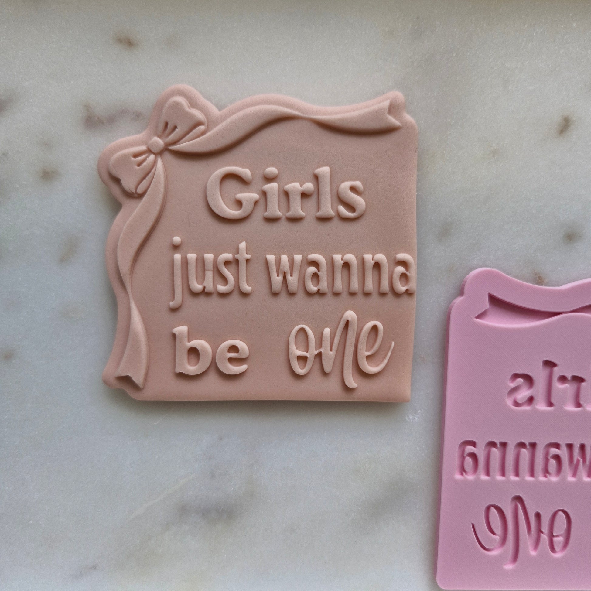Girls Just Wanna be One Cookie Cutter and Stamp, deboss stamped, zoomed out on white marble background