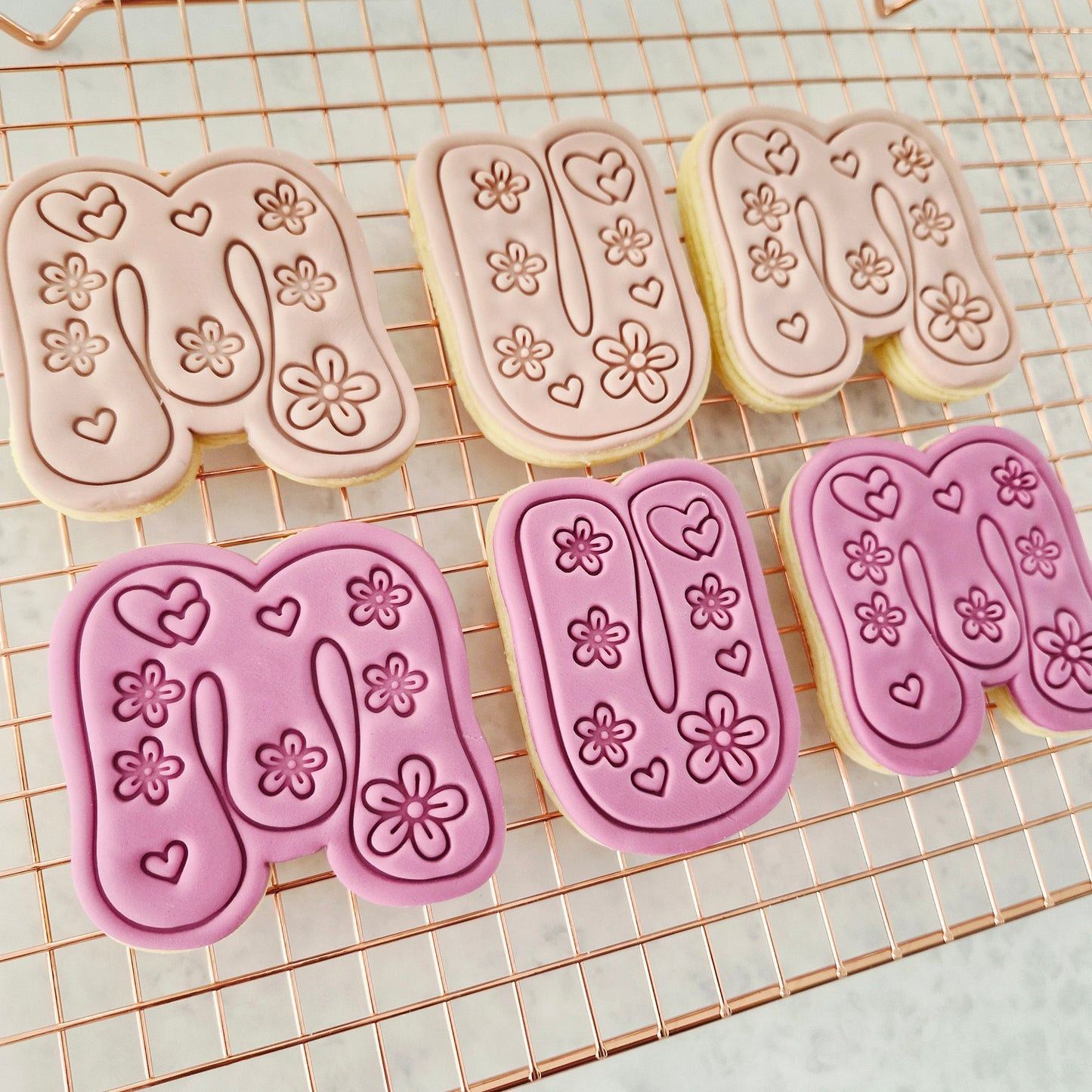 Groovy Mum Cookie Cutter and Stamp on a rose gold baking tray on white marble background