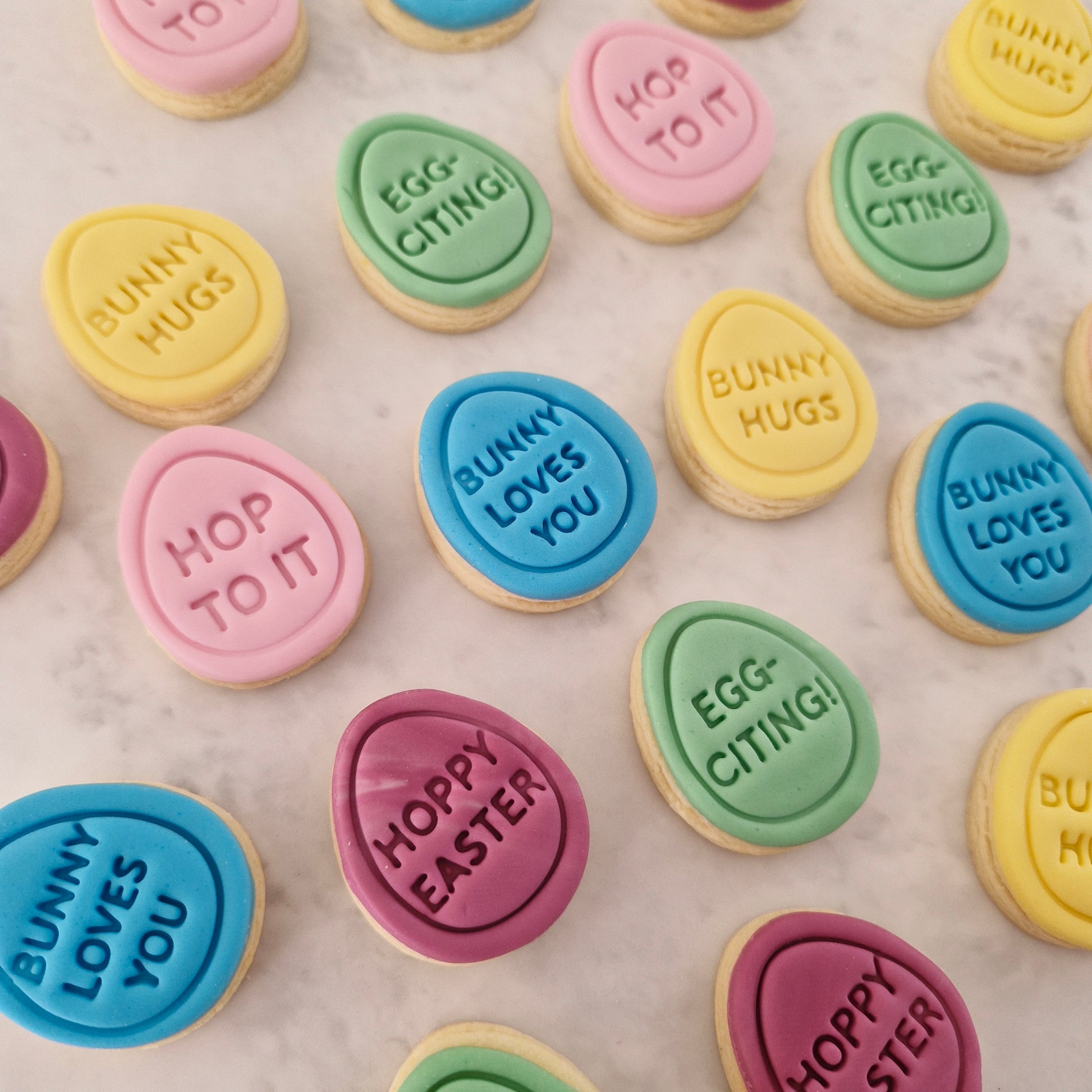 Mini Eggs 4cm Cookie Cutter and Stamp Set multi colored eggs with quotes, on white marble backround