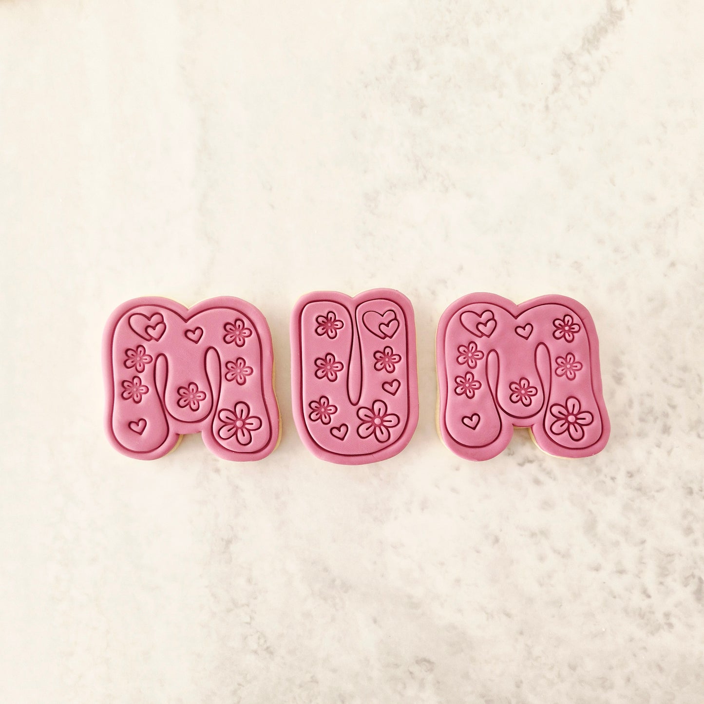 Groovy Mum Cookie Cutter and Stamp letters in sugar cookie form, white marble background