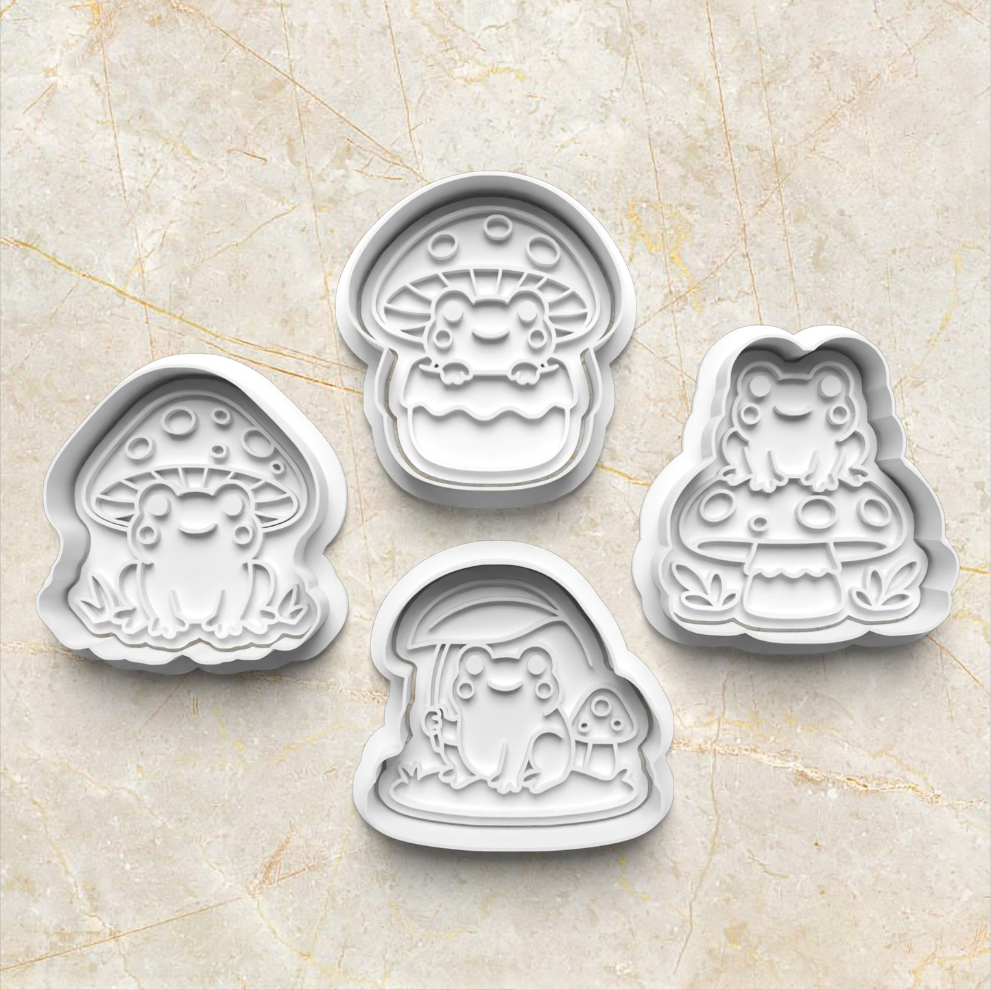 Set of four cartoon-themed frog and mushroom cookie cutters on a beige marble surface Mushroom Frog Set Cookie Cutter and Stamp