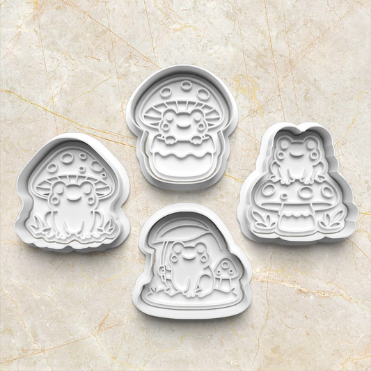 Set of four cartoon-themed frog and mushroom cookie cutters on a beige marble surface Mushroom Frog Set Cookie Cutter and Stamp