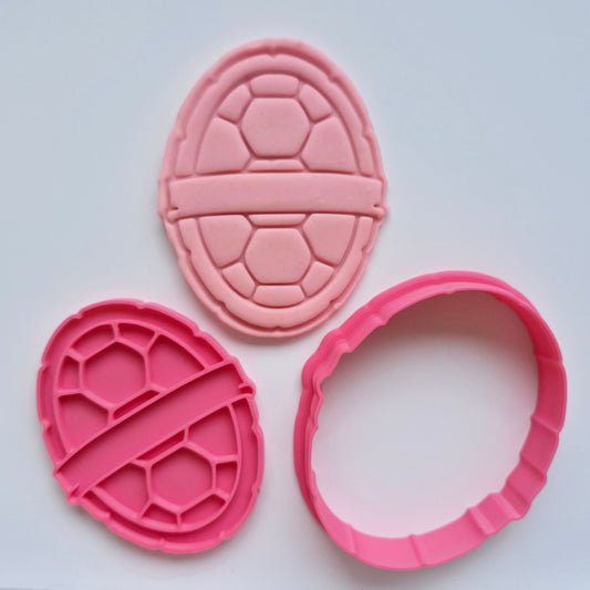 pink fondant, pink cookie cutter and stamp of a turtle shell, on white background