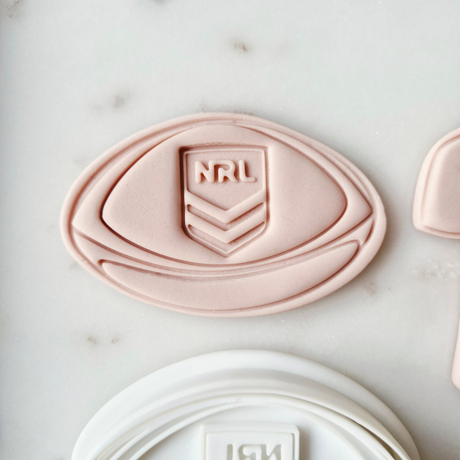 Footy and Jersey Cookie Cutter and Stamp zoomed in on the football Football and Jersey Cookie Cutter and Stamp Baking tool