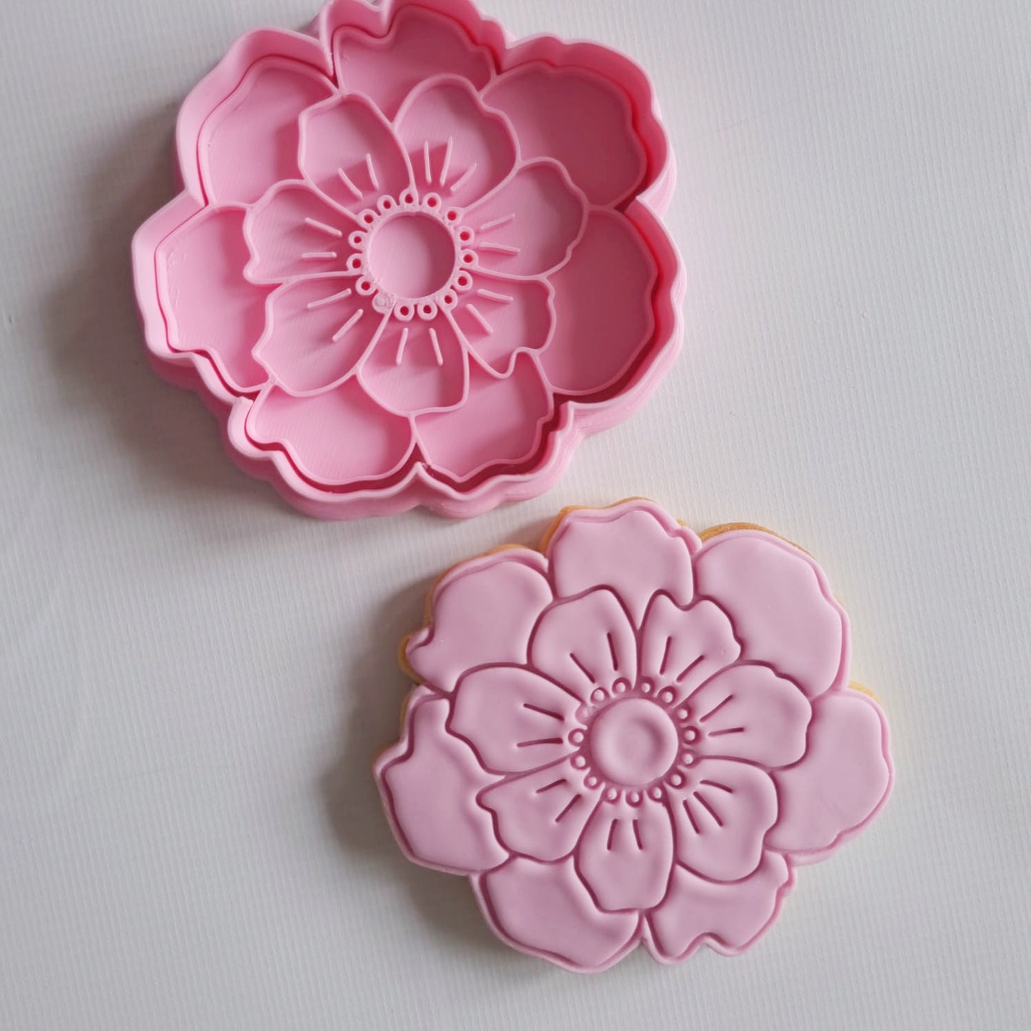 pink peony sugar cookie in the shape of peony flower and a cookie cutter and stamp same shape on a white background Open Peony Flower Cookie Cutter and Stamp