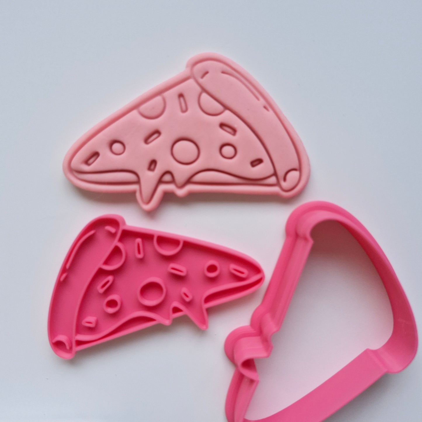 pink fondant and pink pizza cookie cutter stamp on white background