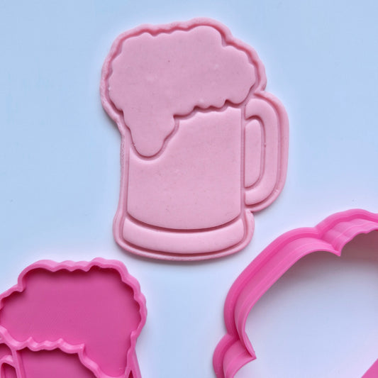 Pink cookie cutters stamped onto pink fondant, showing a plain beer in glass cup with foam on top on white background Plain Beer Mug Cookie Cutter and Stamp 