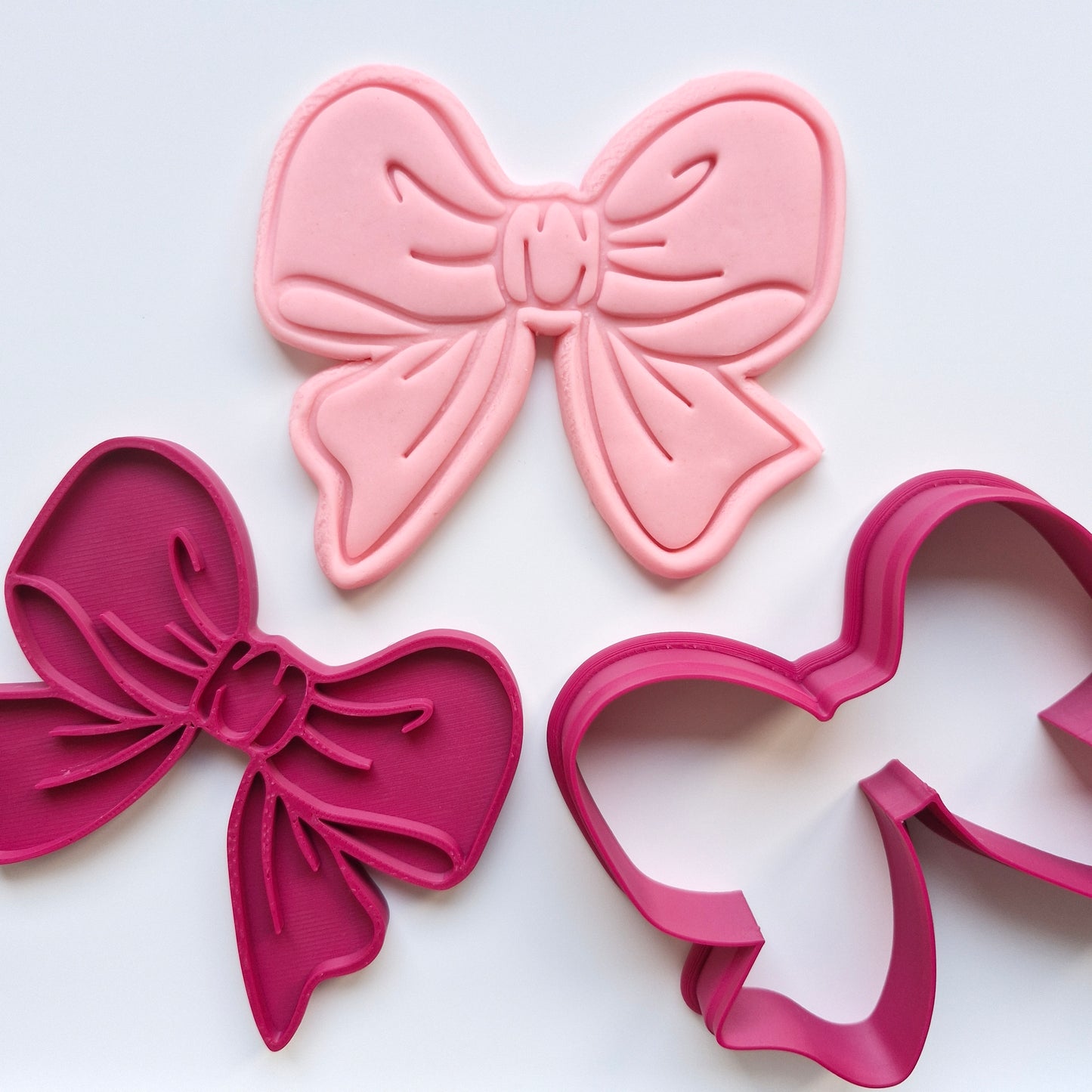Pink and red bow-shaped cookie cutters on a white background Cassey Bow, Cookie Cutter and Stamp