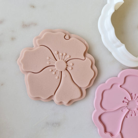Poppy Cookie Cutter and Deboss Stamp zoomed in, on white marble background