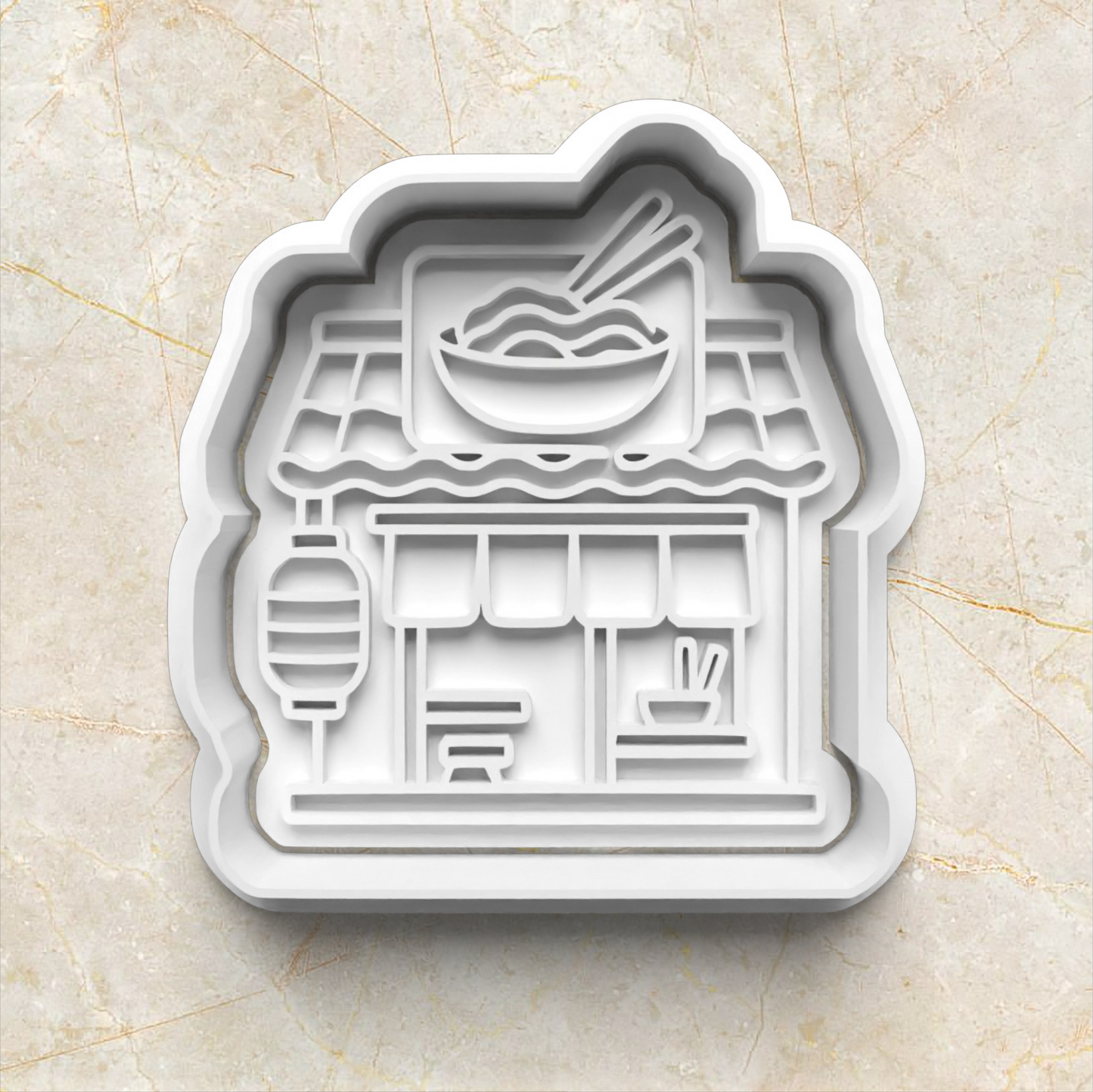 Cookie cutter shaped like a Japanese restaurant with a bowl of noodles on a beige marble background Ramen Noodles Cookie Cutter and Stamp