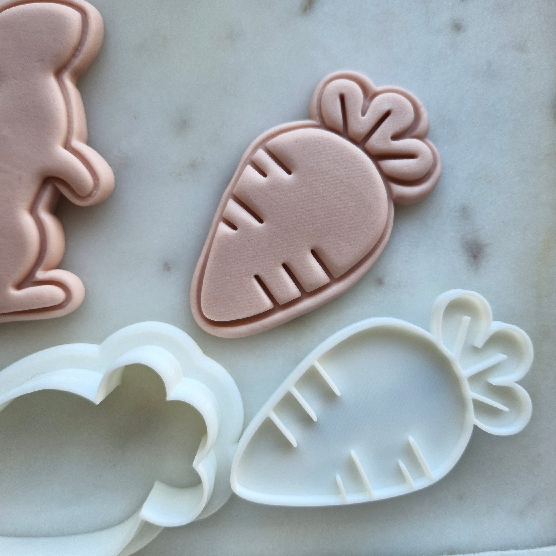 Carrot Cookie Cutter and Stamp - Baking Tool zoomed out on white marble stone