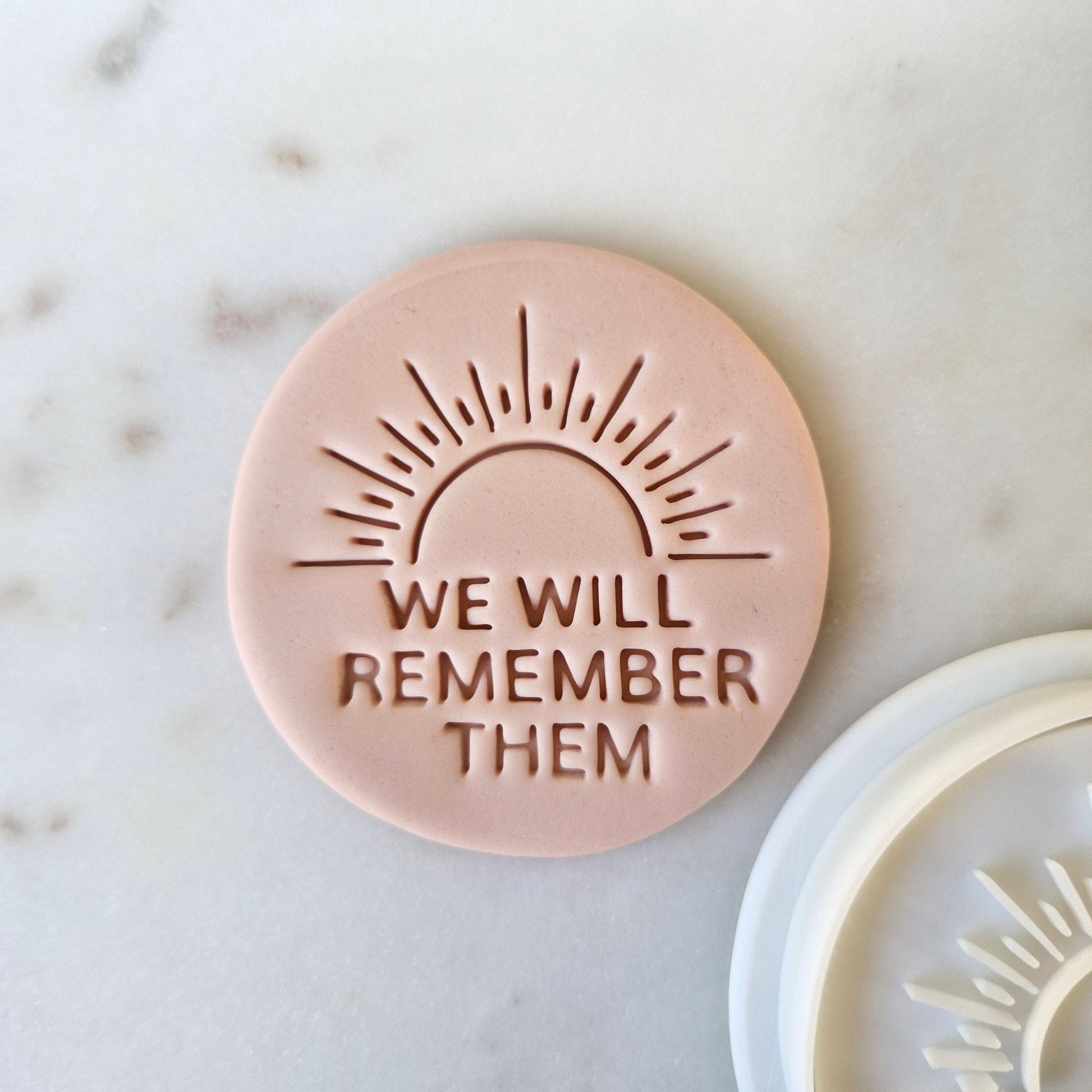 We Will Remember Them Cookie Cutter and Stamp, zoomed in on white marble background