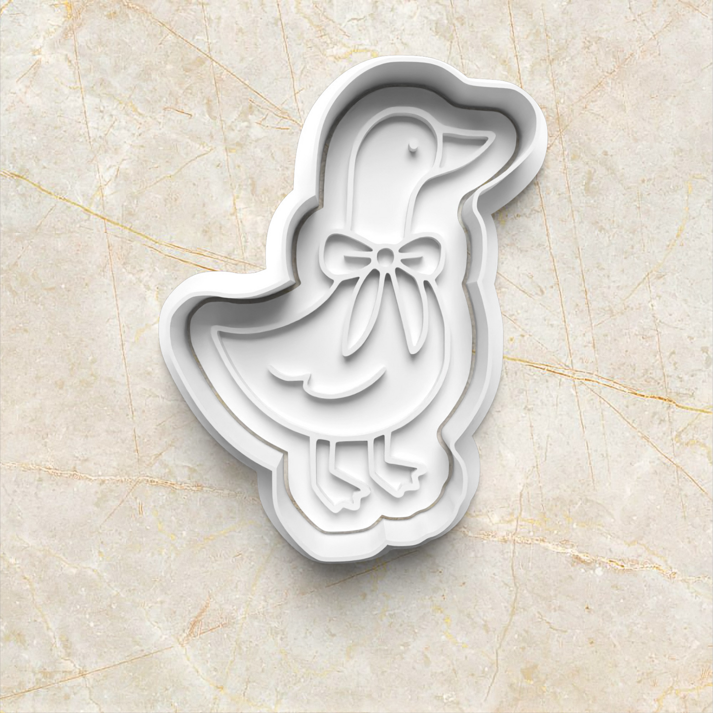 One Silly Goose Cookie Cutter and Emboss Stamp - Baking Tool, goose with bow, on yellow marble