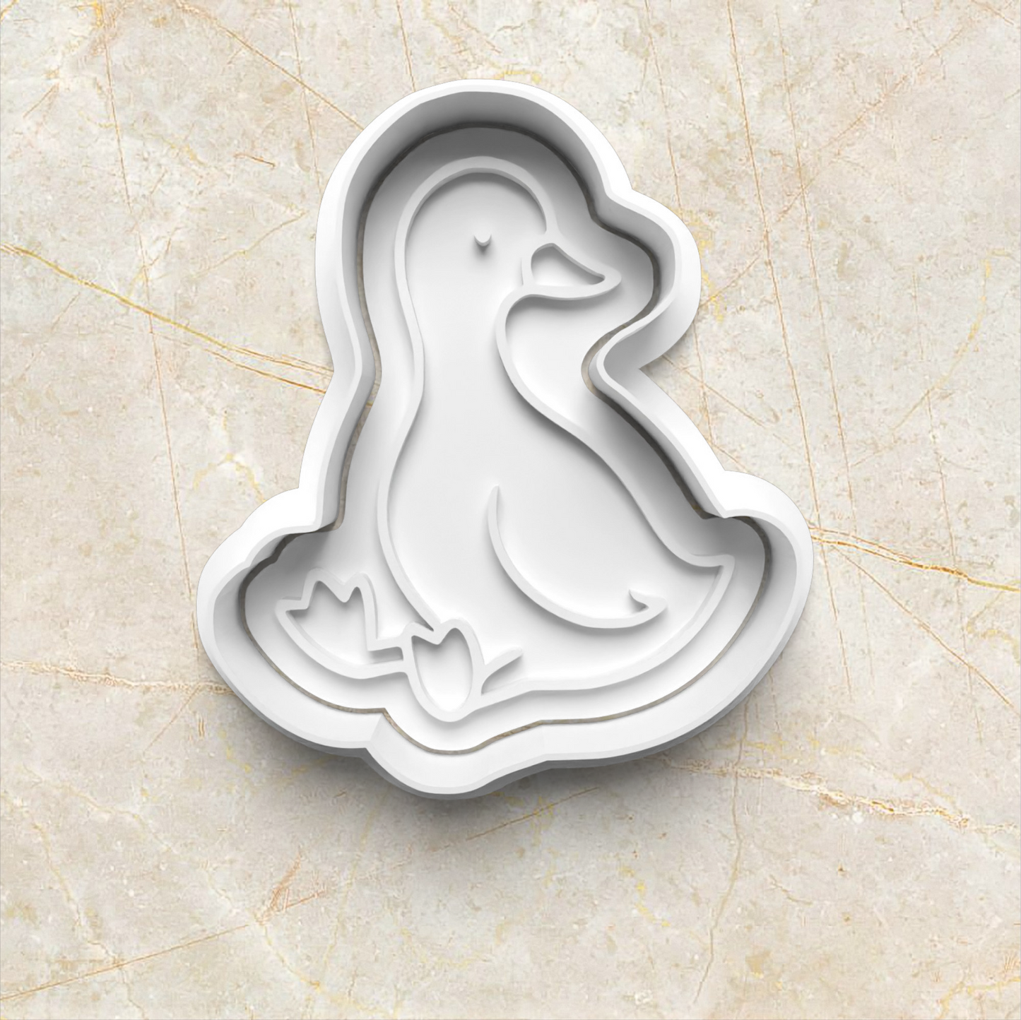 One Silly Goose Cookie Cutter and Emboss Stamp - Baking Tool, sitting goose on yellow marble