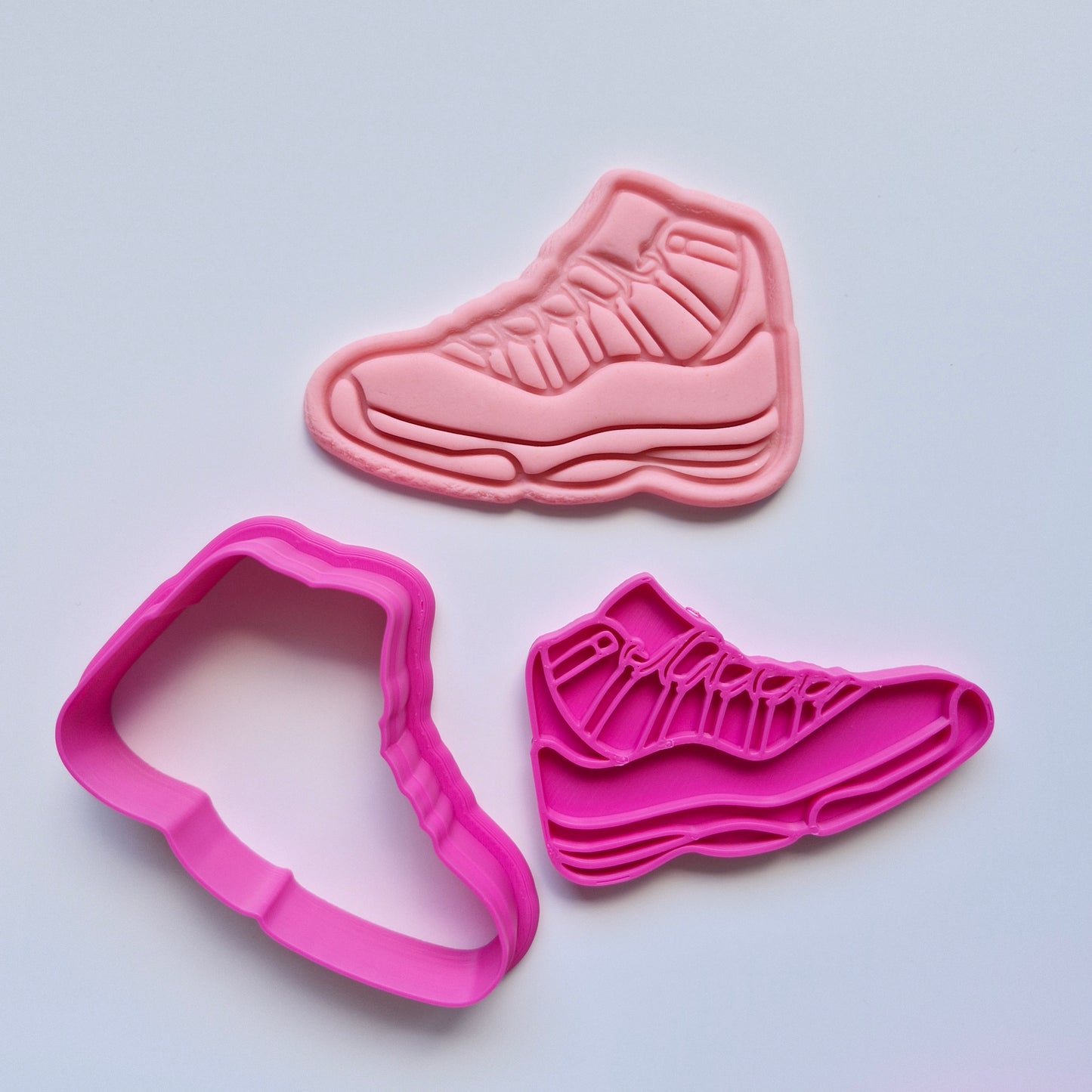 pink and cookie cutter stamp with pink fondant in the shape of sneakers. Activewear Outfit Set Cookie Cutter and Stamp. Athletic Shoes Cookie Cutter and Stamp