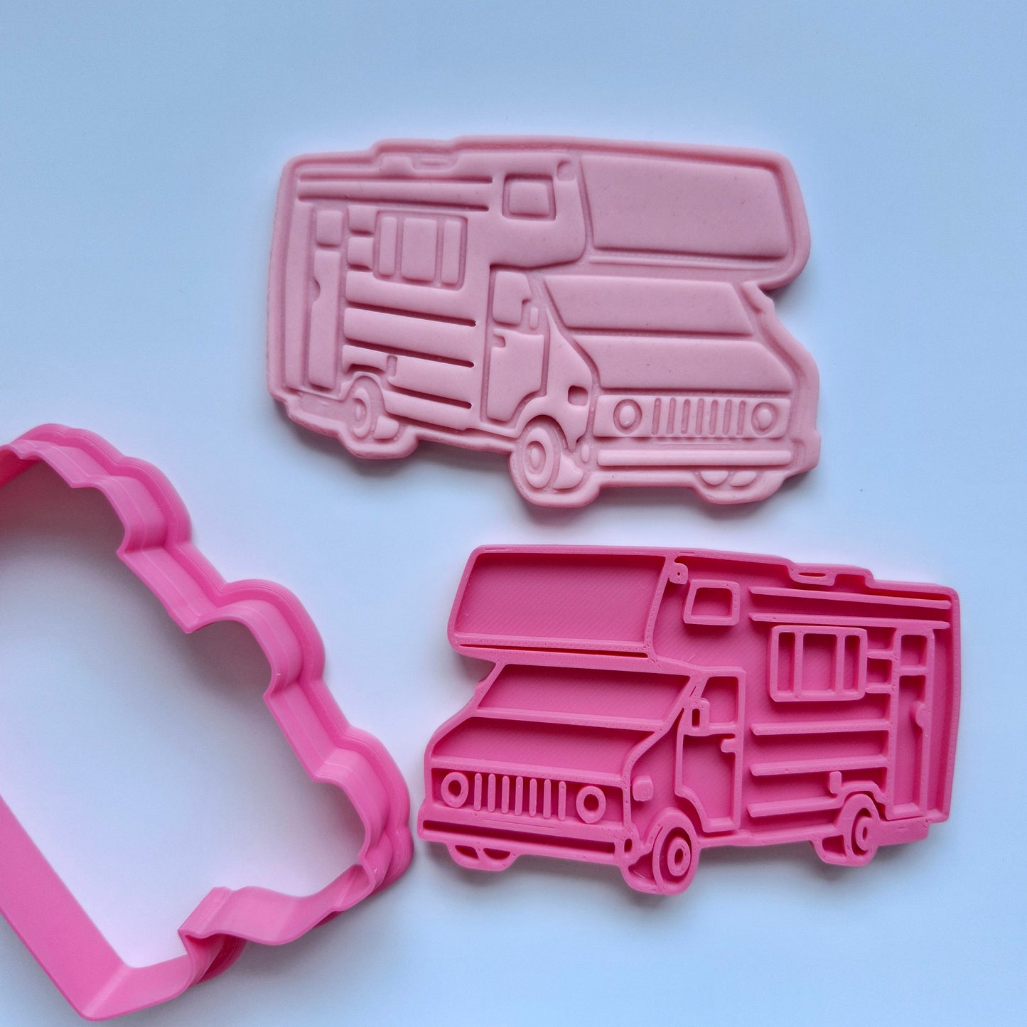 pink fondant stamped and cut in the shape of a caravan with pink cookie cutter and stamp on white background zoomed out Caravan Cookie Cutter and Stamp