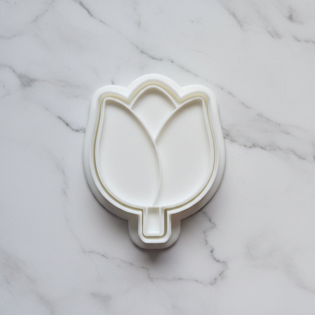 Tulip Cookie Cutter and Stamp on white marble backround